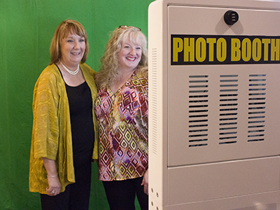 2 people with a green screen