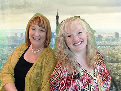 two friends pose in front of a green screen in the photo booth