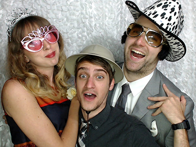 Three friends enjoy a photo booth